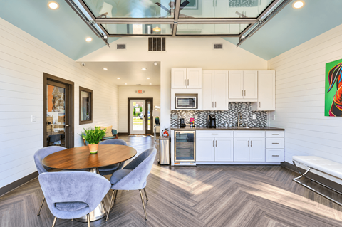 A modern kitchen with a dining table and chairs.