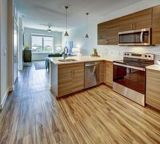 kitchen appliances with brown cabinets at Brixton South Shore, Austin, 78741