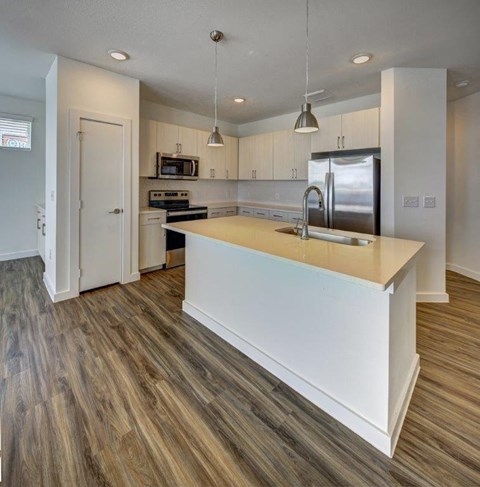 a kitchen with a counter top and a refrigerator