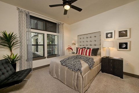 a bedroom with a bed and a ceiling fan