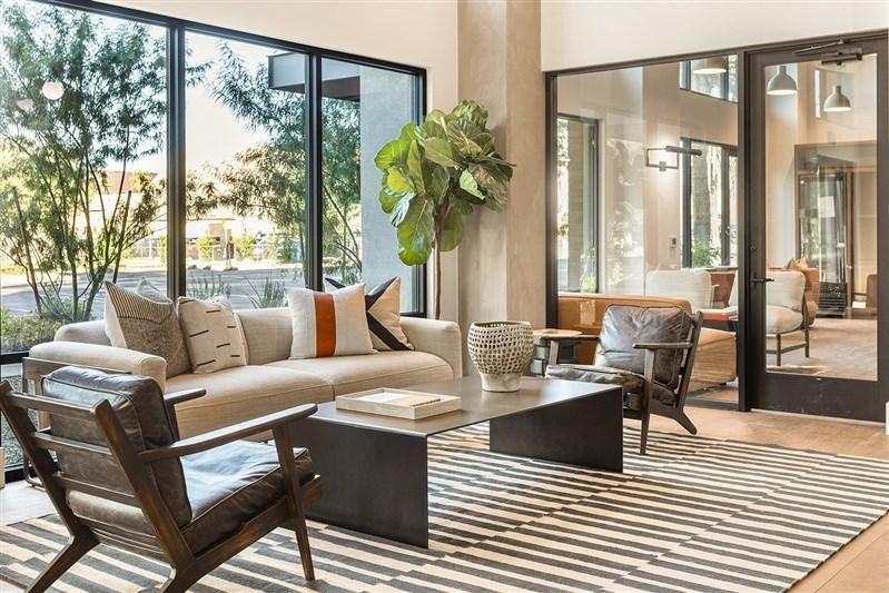 A living room with a large couch and a chair.