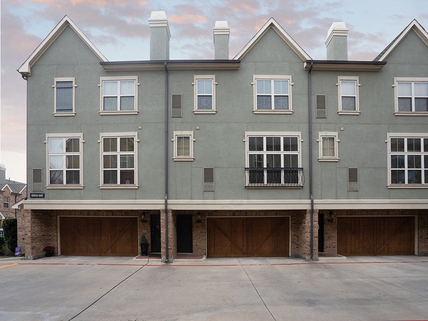 the front of a building with three garage doors