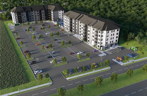 A parking lot in front of apartment buildings.
