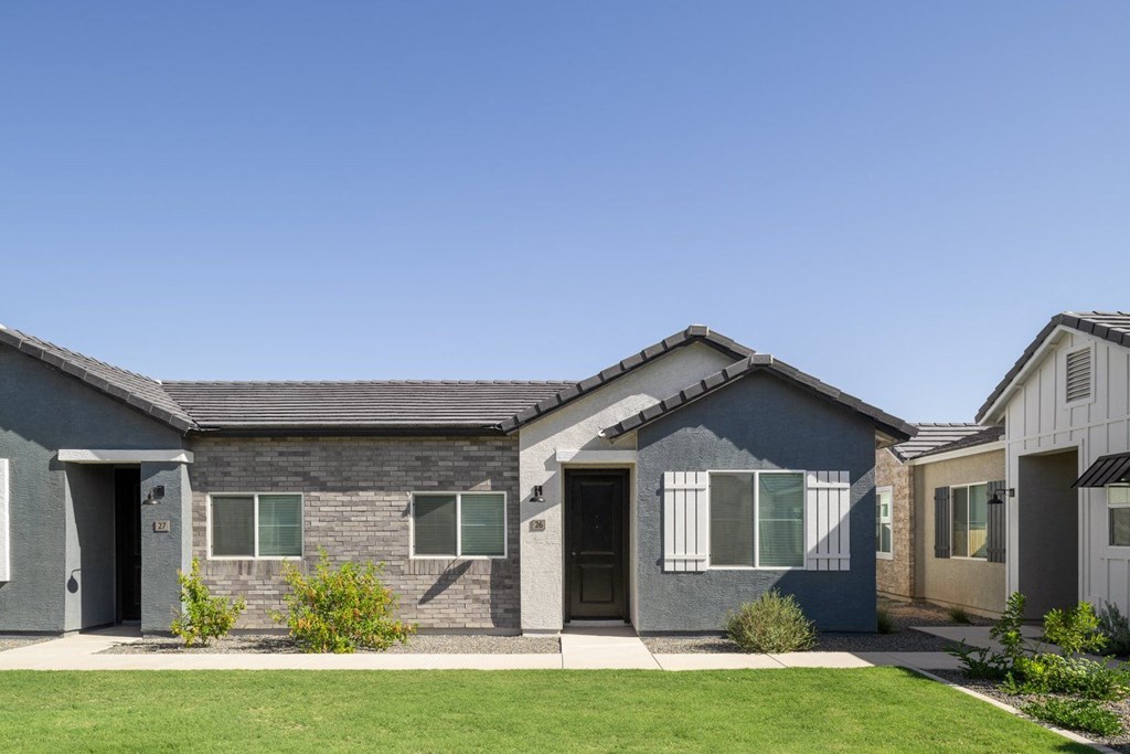 A row of houses with grey and white exteriors.