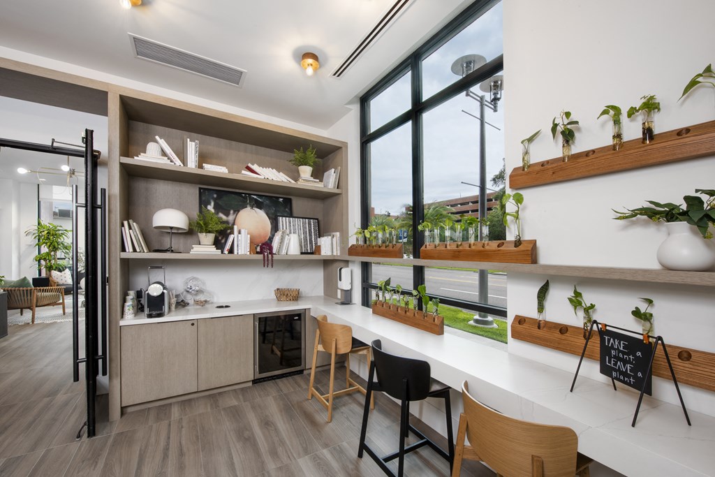 a kitchen with white countertops and a large window