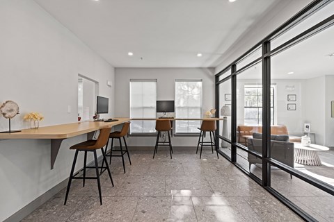 A modern dining room with a glass door leading to a balcony.