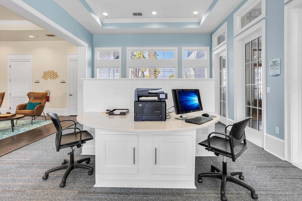 a home office with a white desk and a computer