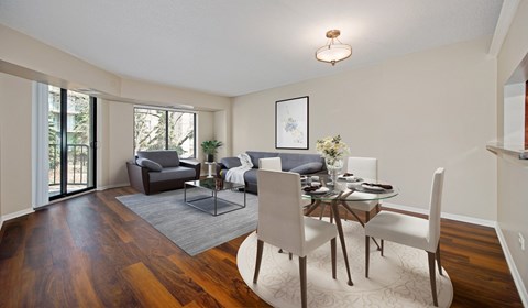 A dining room with a glass table and chairs.