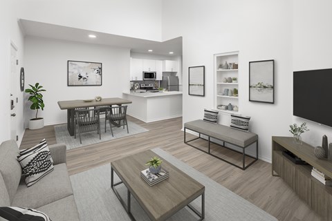 A modern living room with a grey sofa, a coffee table, and a kitchen area in the background.