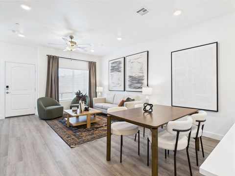 A modern living room with a wooden table and chairs.