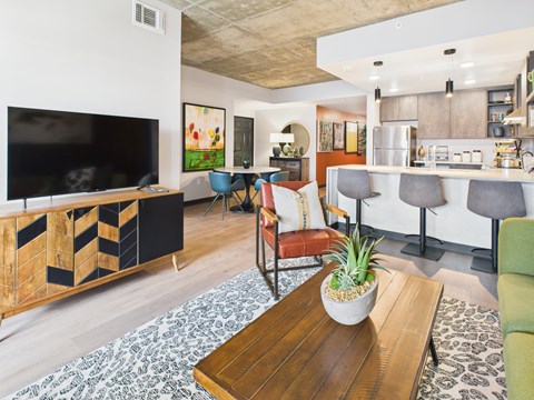 A living room with a wooden coffee table and a television.