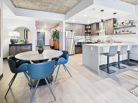 A modern kitchen with a dining table and chairs.