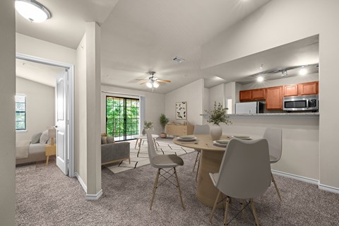 A modern kitchen with a dining table and chairs.