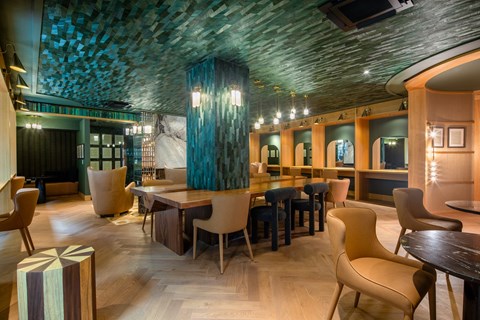 A modern dining room with a wooden table and chairs.