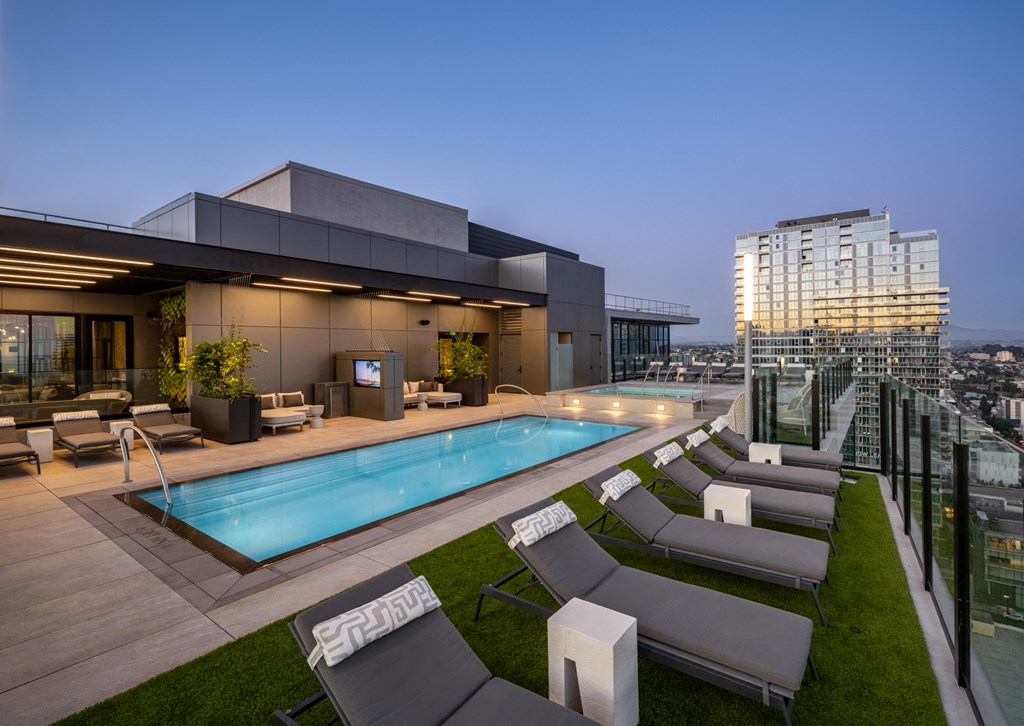 a pool on the rooftop of a building at night