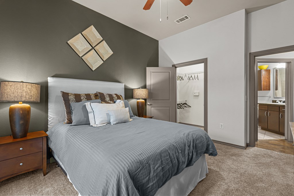 a bedroom with a large bed and a bathroom