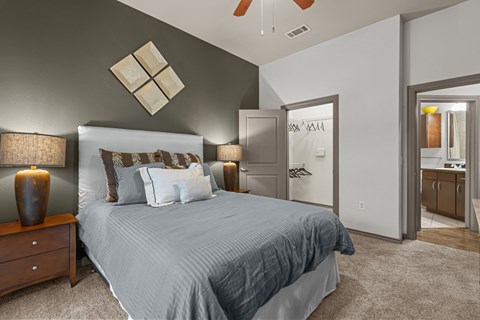 a bedroom with a large bed and a bathroom