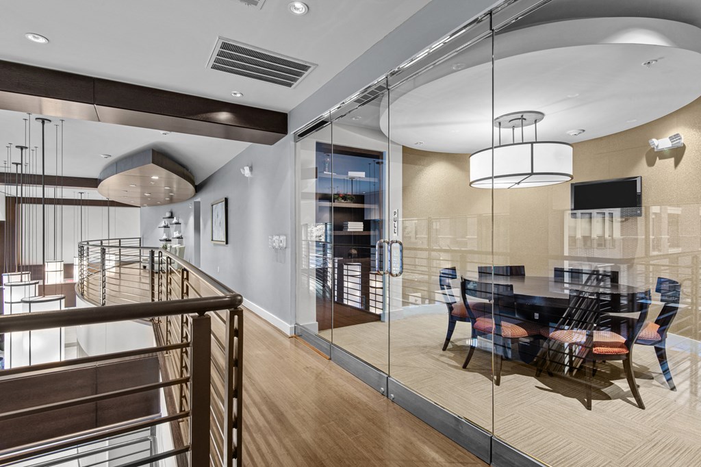 a dining room with glass walls and a table and chairs