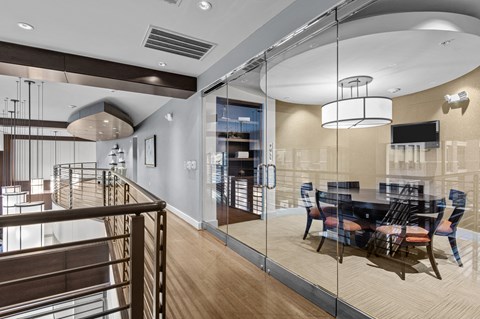 a dining room with glass walls and a table and chairs
