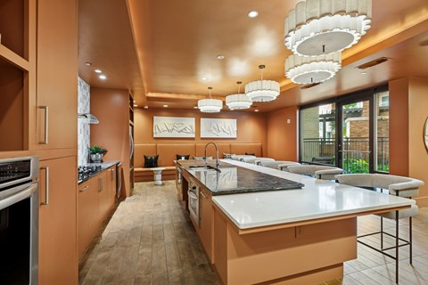 A modern kitchen with a long counter and a large island.