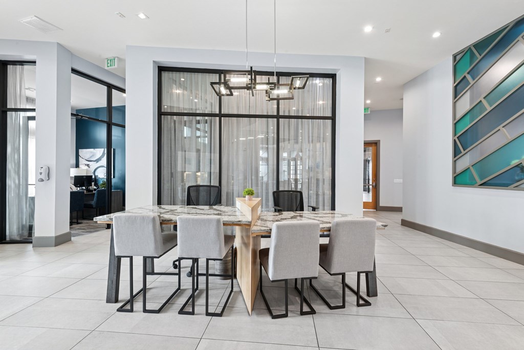 A modern dining room with a large table and chairs.