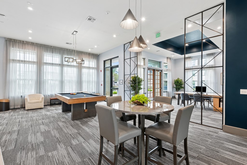 A conference room with a table and chairs.