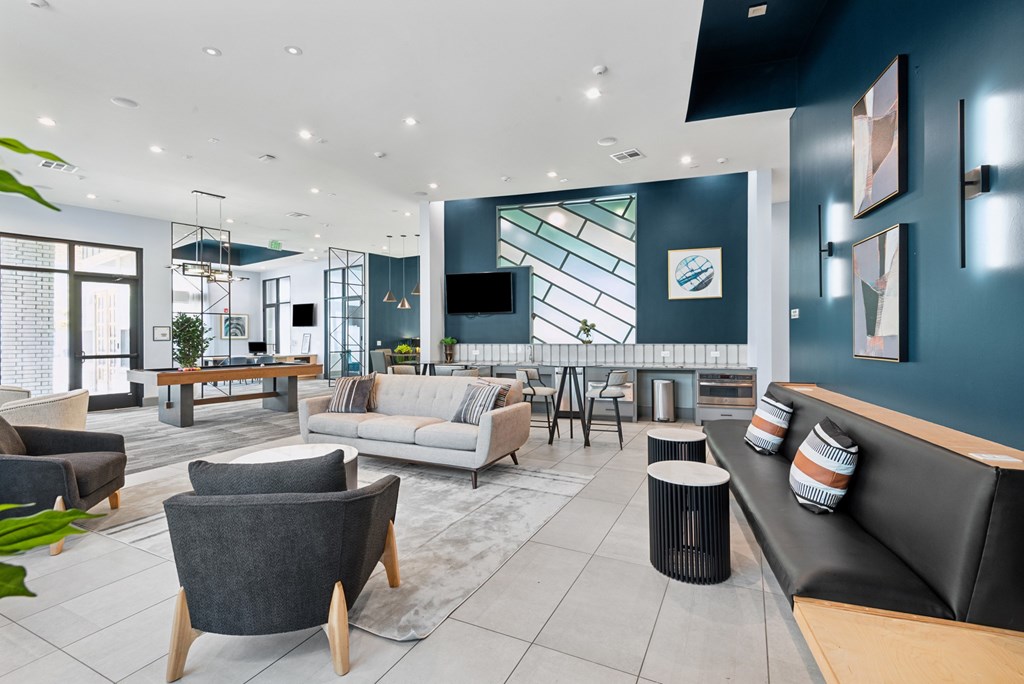 A modern living room with a grey sofa and a wooden coffee table.
