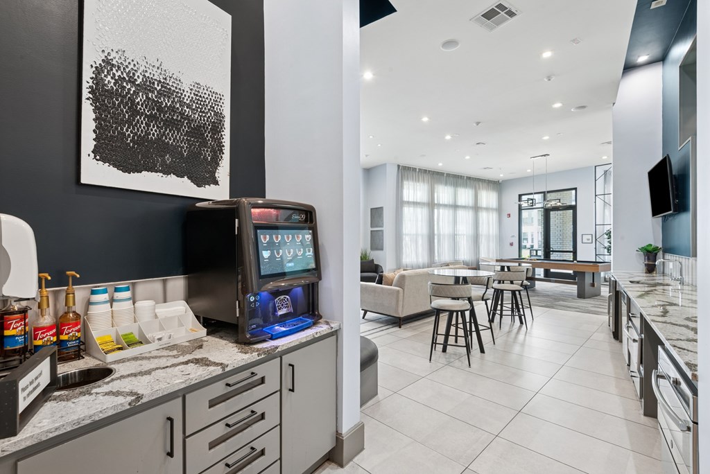 A modern kitchen with a black and white artwork on the wall.