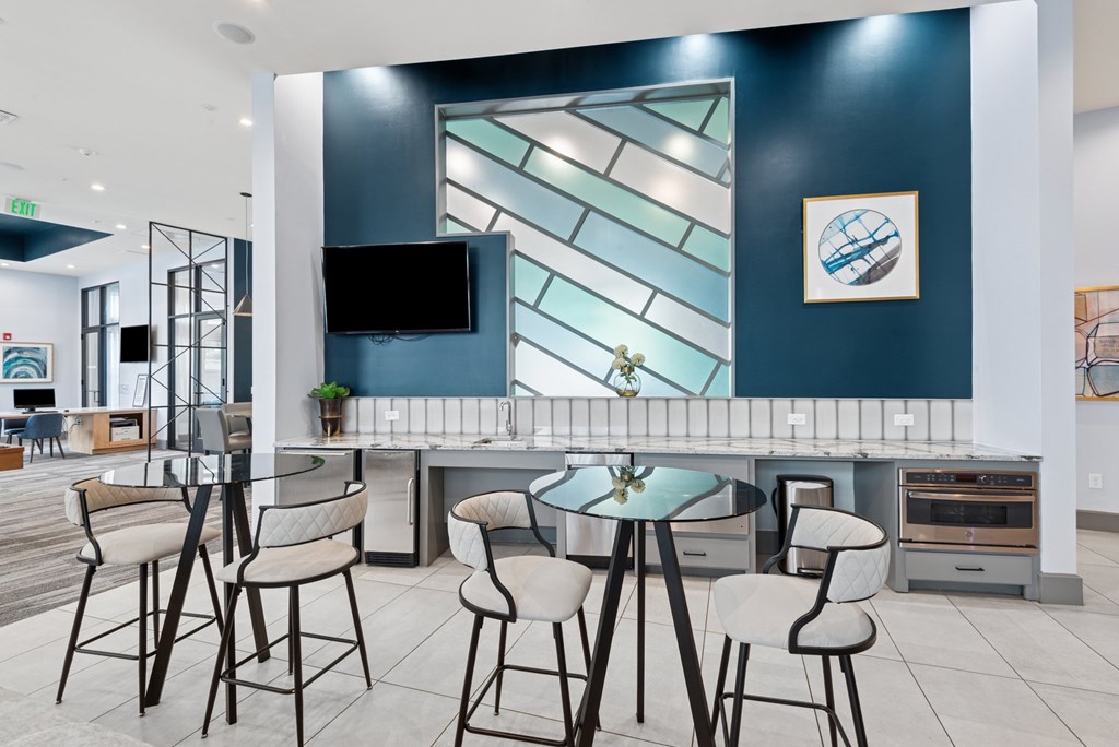 A modern dining area with a glass table and chairs.
