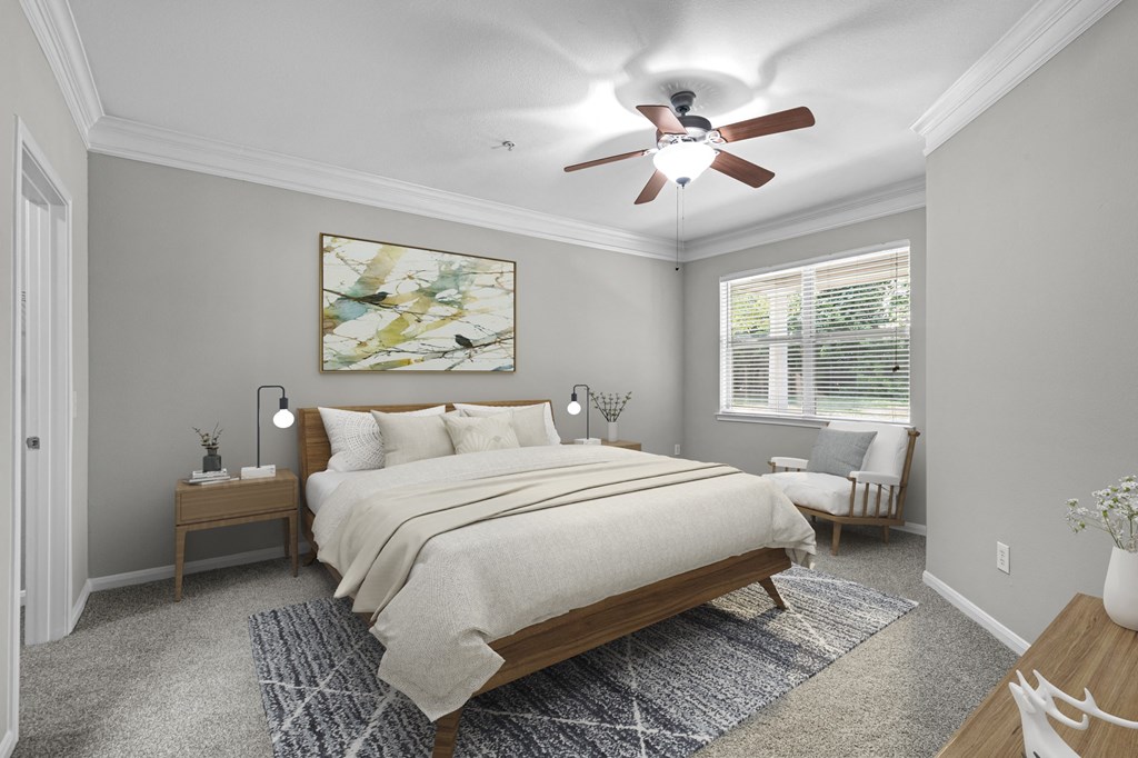 a bedroom with a ceiling fan and a bed