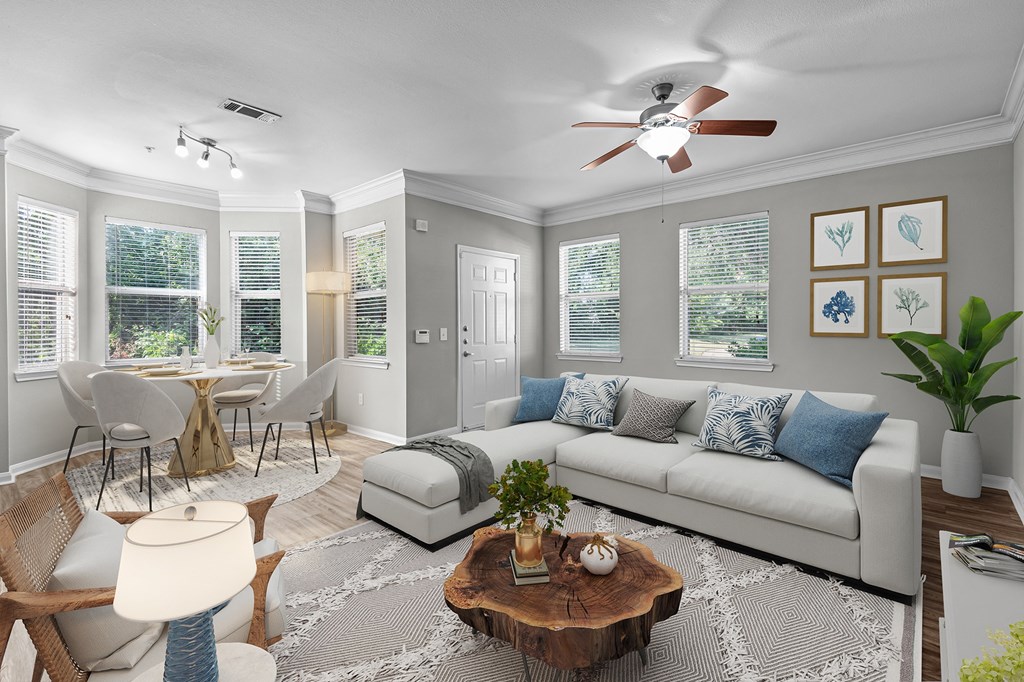 a living room with a couch and a ceiling fan