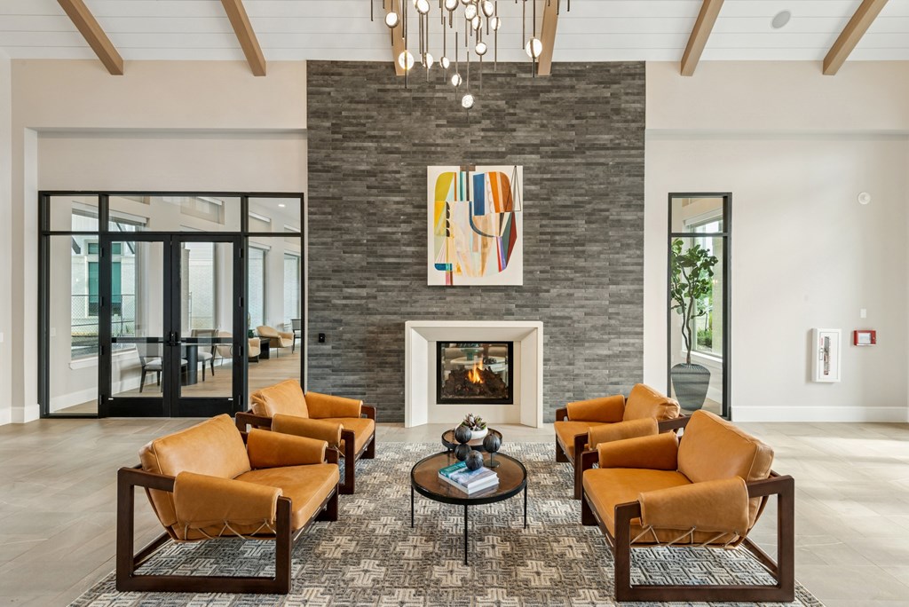 A living room with a fireplace and a painting above it.