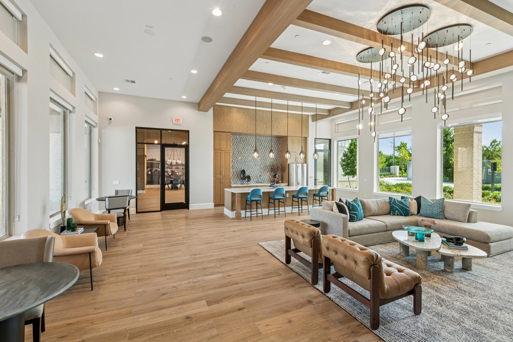 A spacious living room with a wooden floor and a large window.