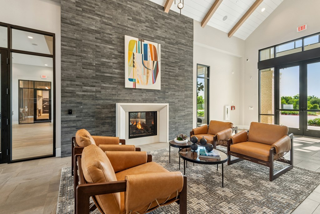 A living room with a fireplace and a painting above it.