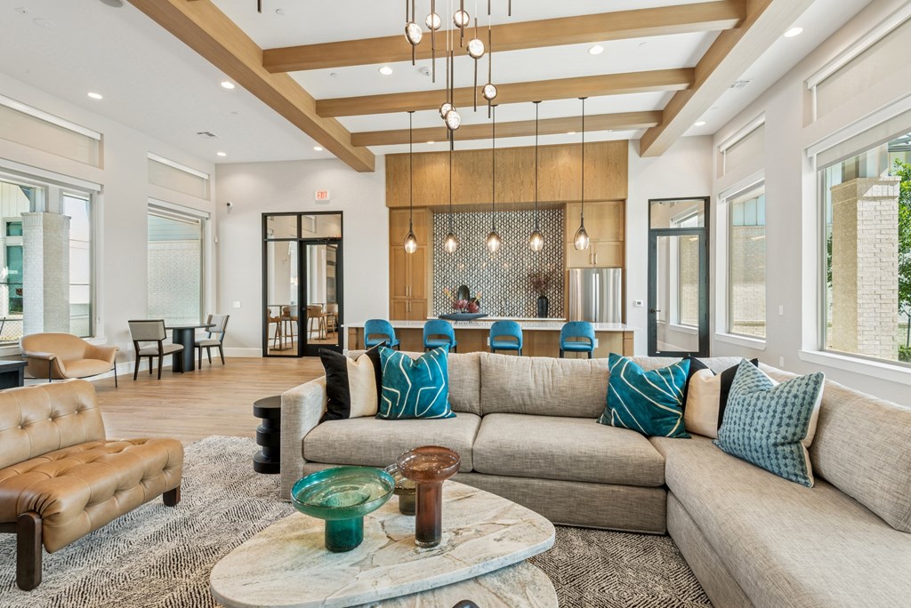 A living room with a brown leather sofa and a coffee table.