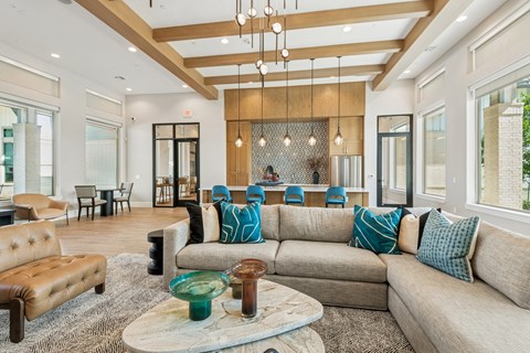 A living room with a brown leather sofa and a coffee table.