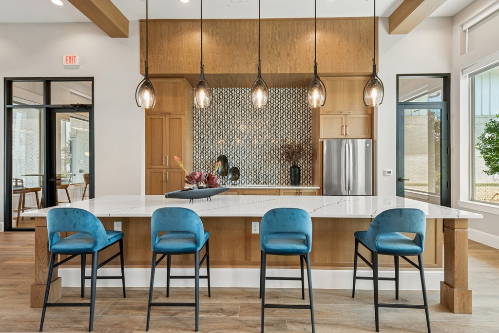 A kitchen with a table and chairs.