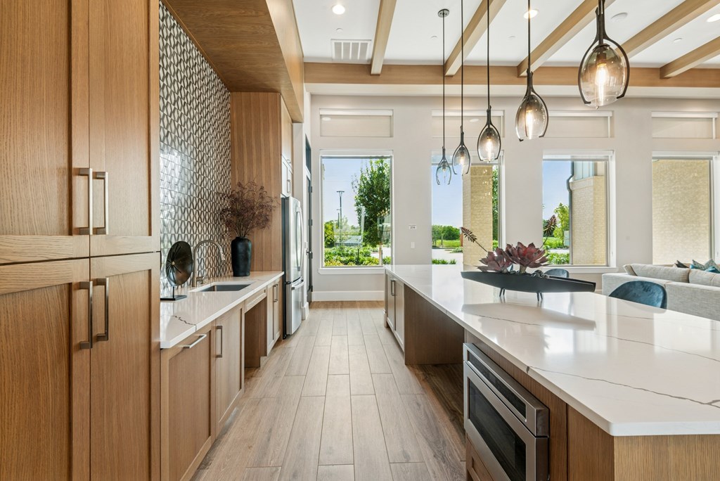 A modern kitchen with wooden cabinets and a white countertop.