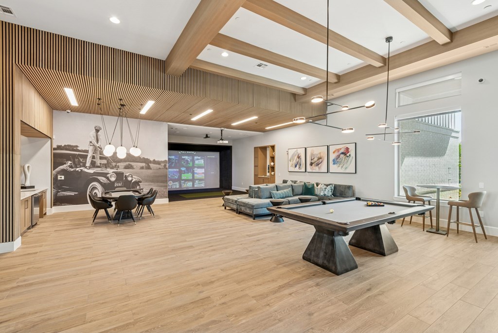 A room with a pool table and a couch.