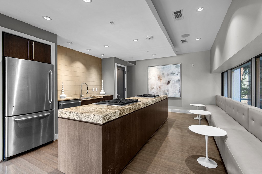 a large kitchen with granite counter tops and stainless steel appliances
