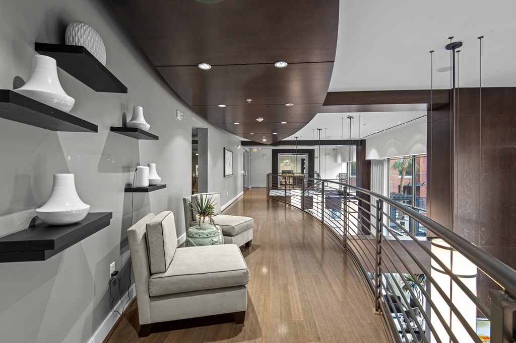 a large living room with a spiral staircase and white furniture
