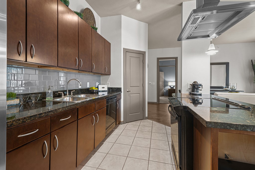 a kitchen with wooden cabinets and granite counter tops
