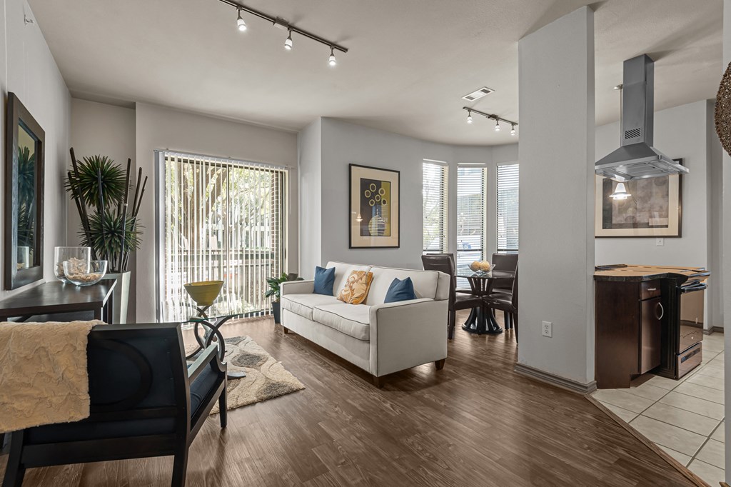 an open living room and dining room with a couch and a chair