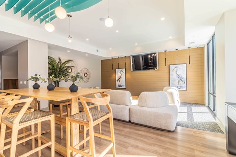 A modern dining room with a wooden table and chairs.