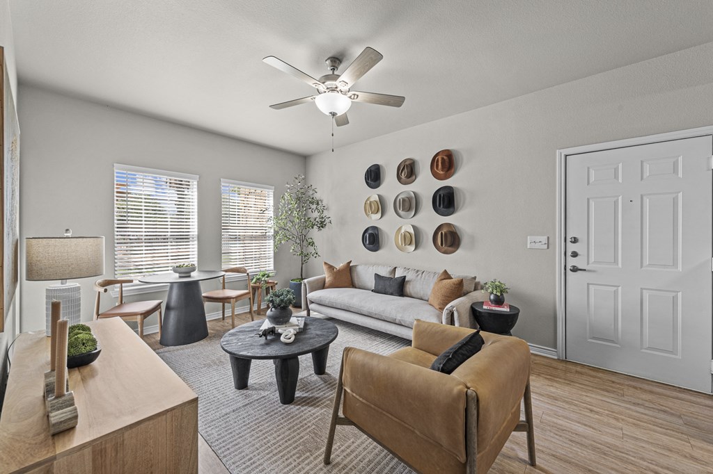 a living room with a ceiling fan and a couch