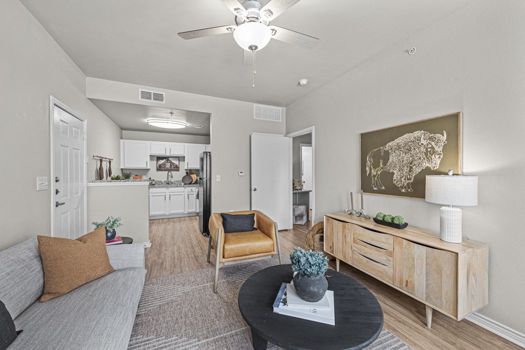 an open living room and kitchen with a ceiling fan