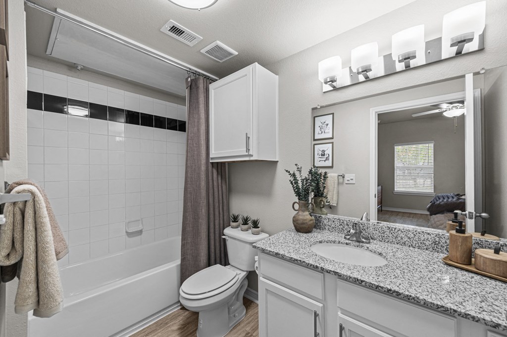 a bathroom with a sink and a toilet and a shower