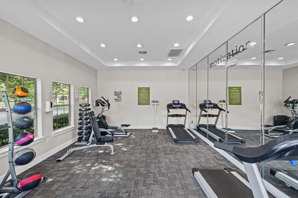 a gym with treadmills and other exercise equipment at the enclave at woodbury