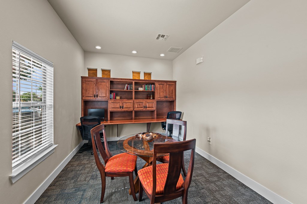 a dining room with a table and chairs and a window