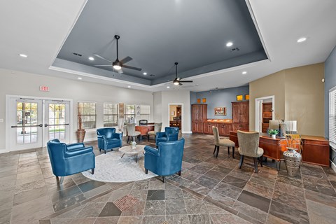 a lobby with blue chairs and tables and a bar